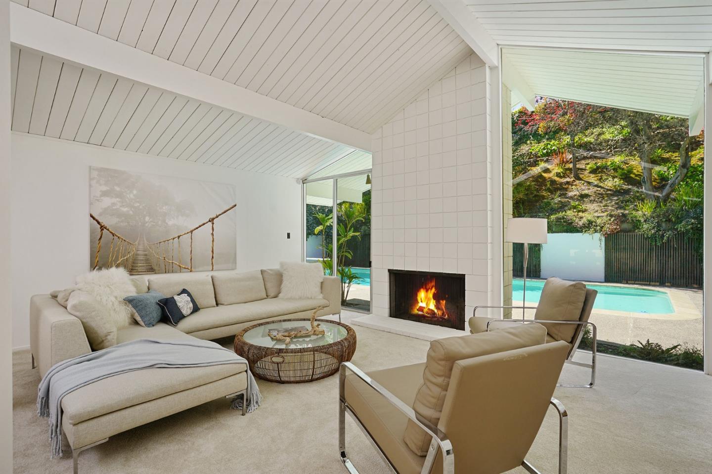 1775 Hunt Drive Burlingame, CA 94010 - Photo 11 of 37 a living room with furniture a fireplace and a floor to ceiling window