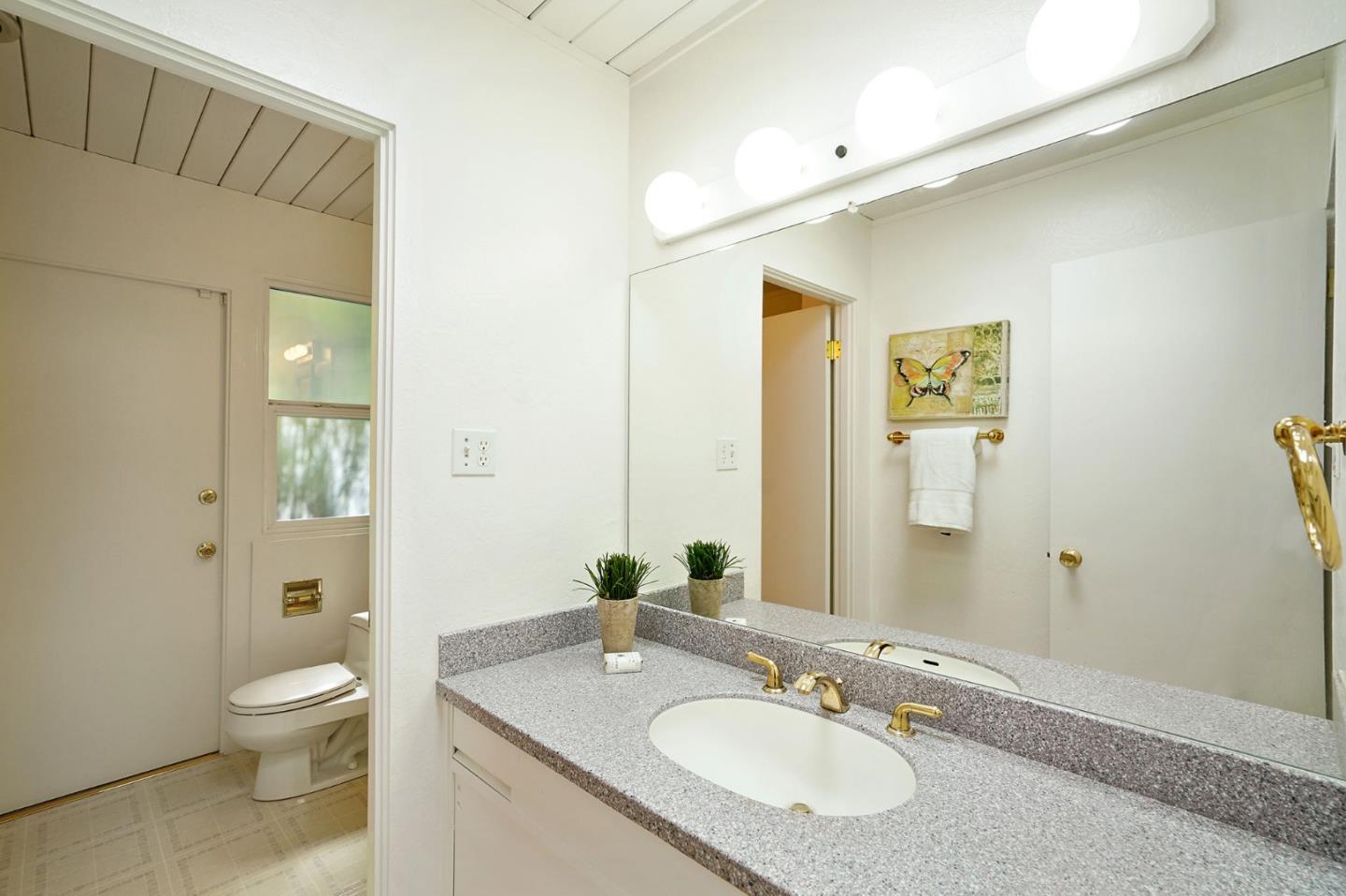 1775 Hunt Drive Burlingame, CA 94010 - Photo 33 of 37 a bathroom with a granite countertop sink toilet and shower