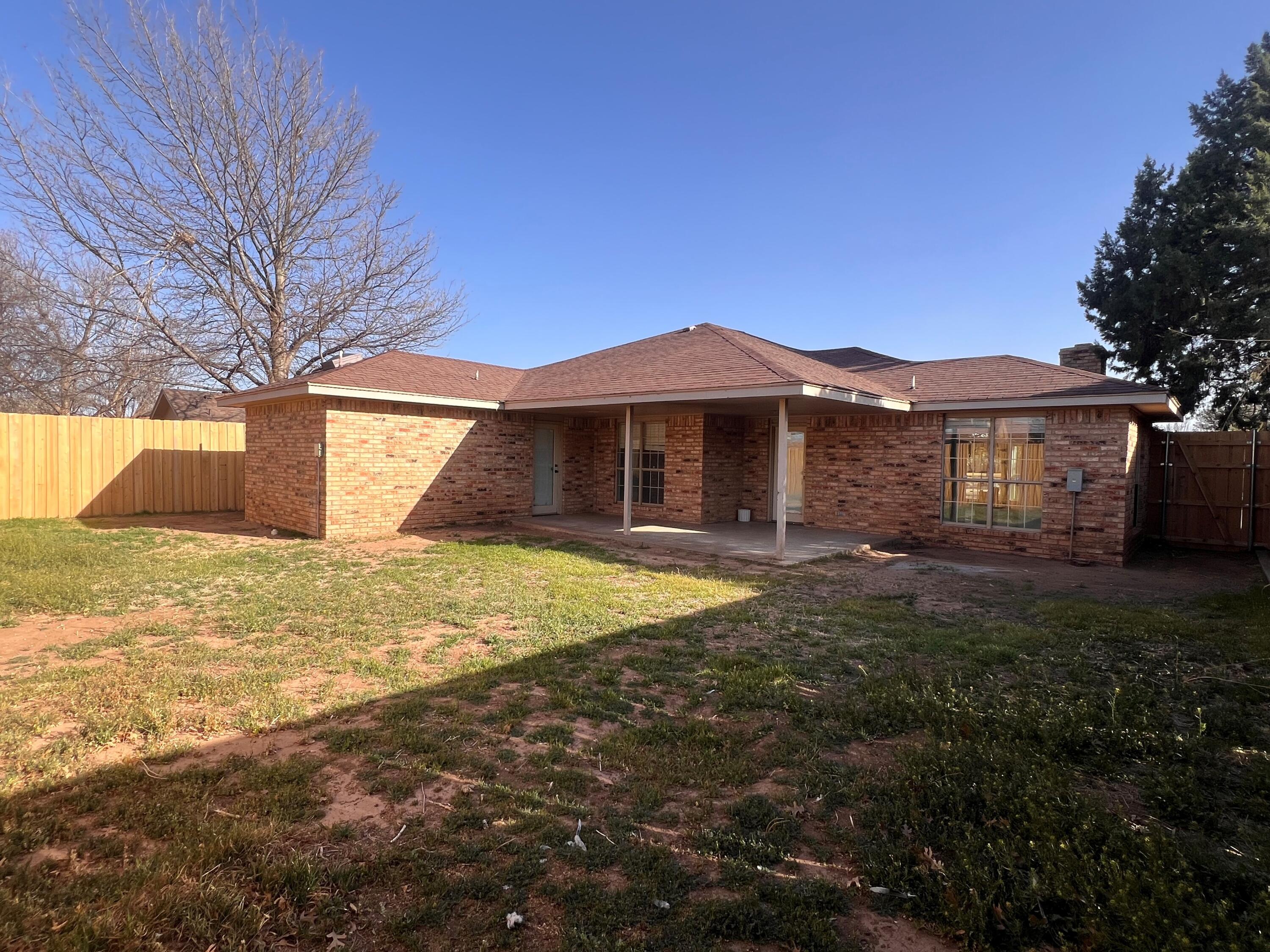 5718 95th Street Lubbock, TX 79424 - Photo 15 of 16 a view of a house with a yard