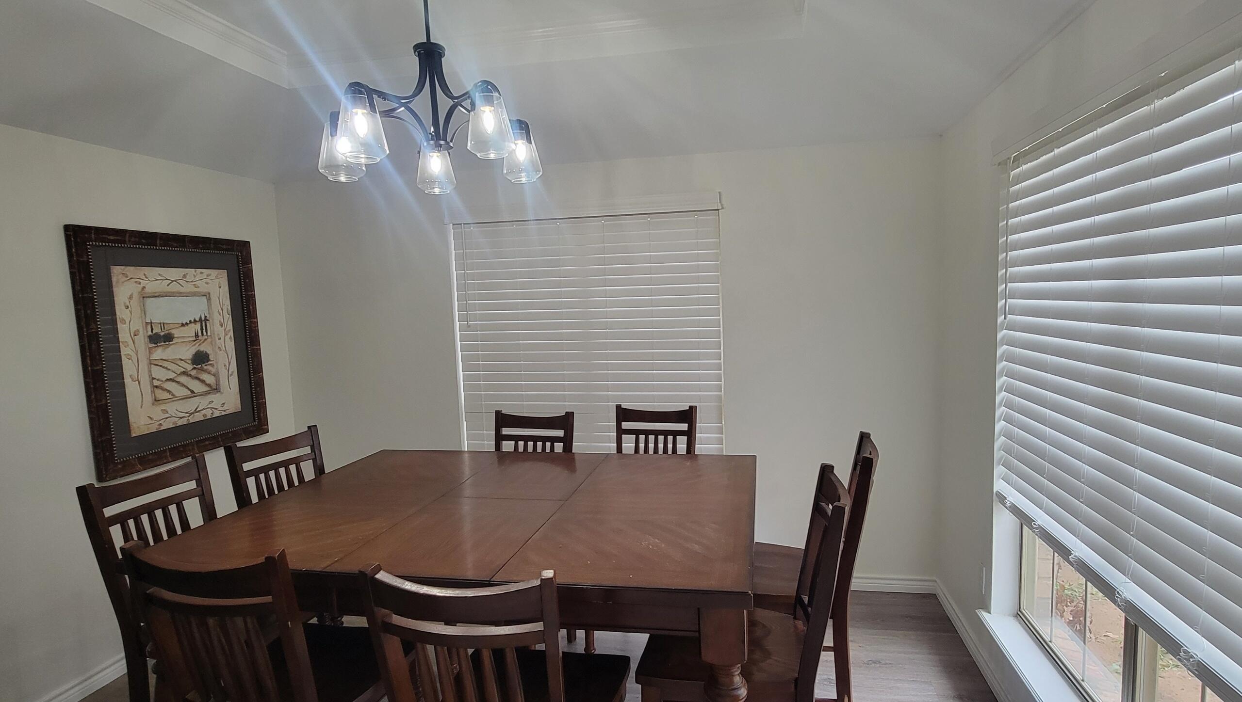 5718 95th Street Lubbock, TX 79424 - Photo 6 of 16 a view of a dining room with furniture and wooden floor