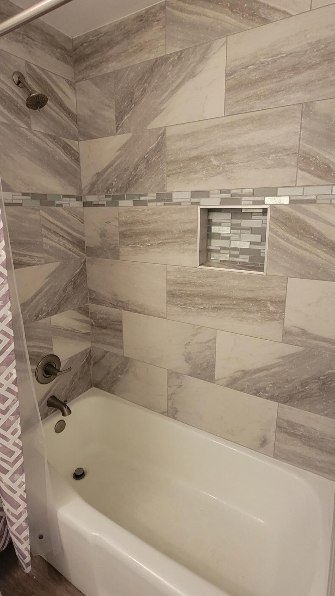 5718 95th Street Lubbock, TX 79424 - Photo 9 of 16 a bathroom with a bathtub