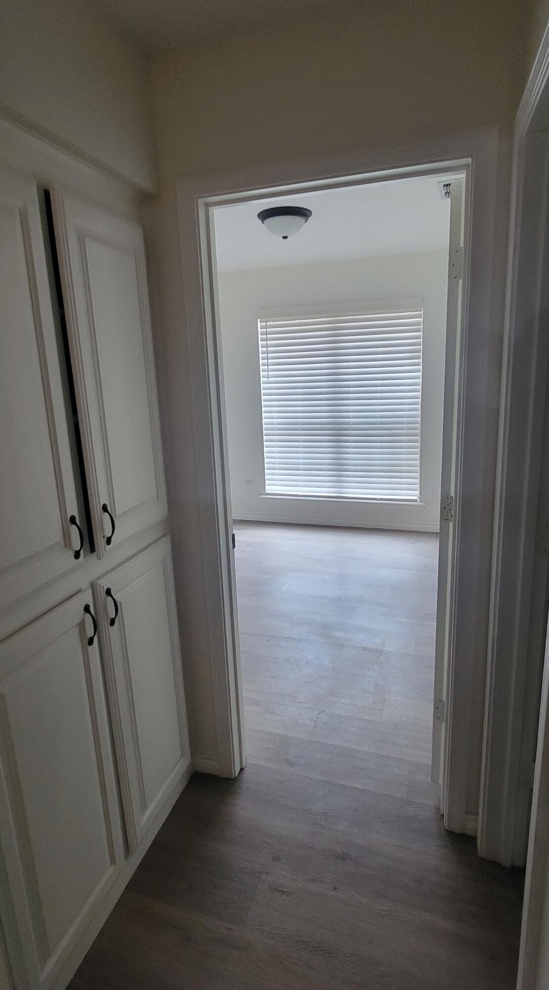 5718 95th Street Lubbock, TX 79424 - Photo 10 of 16 an empty room with wooden floor and a window