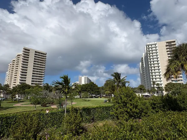 a view of a chair and tables with umbrella in the patio