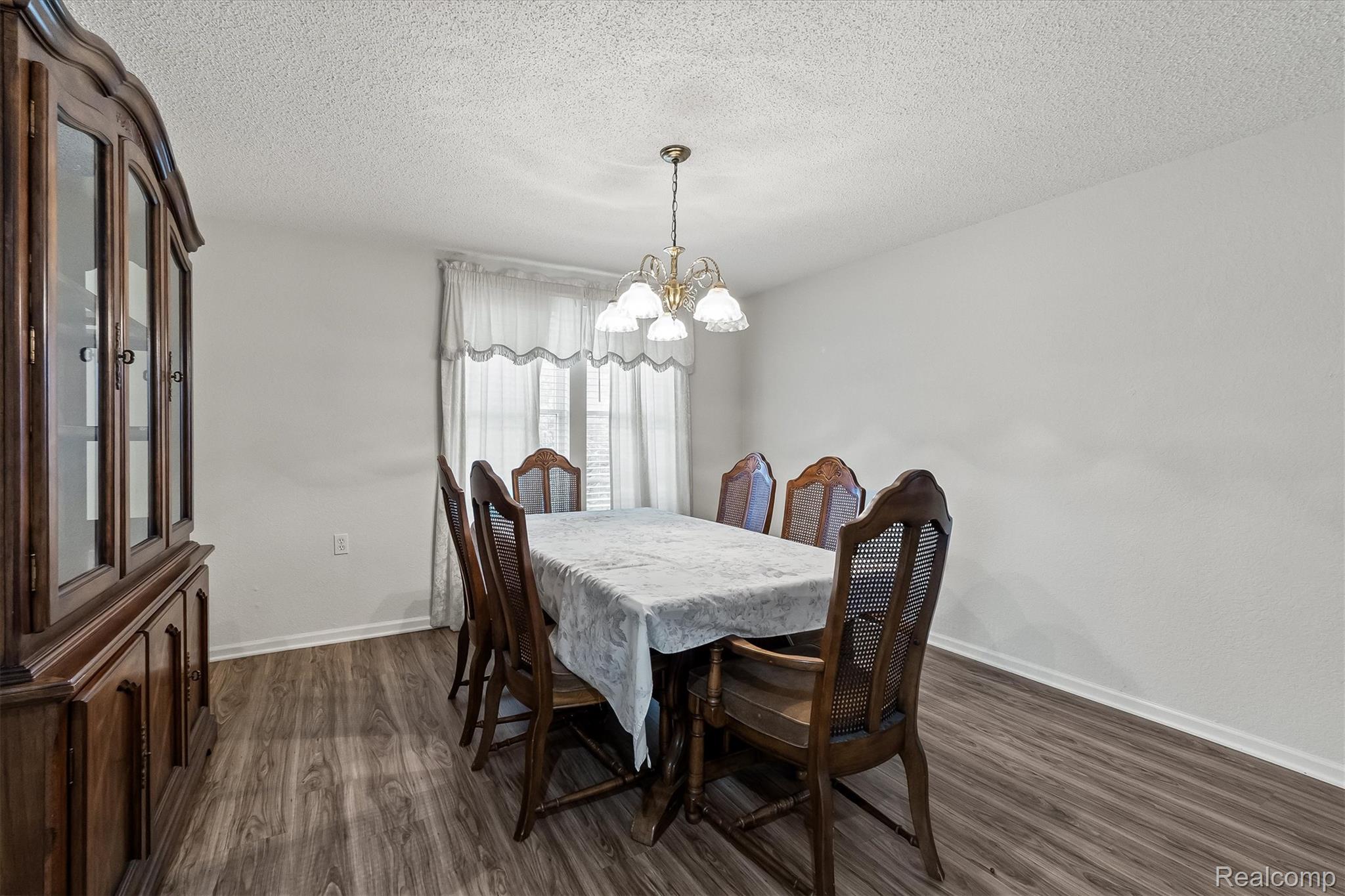 3553 North State Road Owosso, MI 48867 - Photo 10 of 45 Wood-finish flooring with white baseboards and light-toned walls