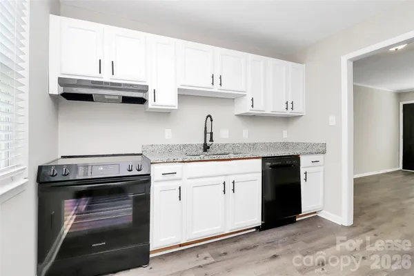 a kitchen with stainless steel appliances granite countertop a stove and a sink