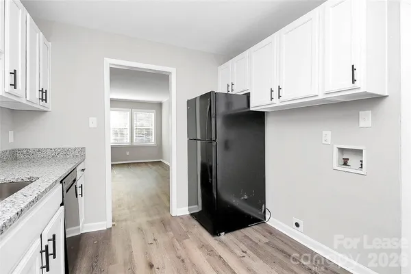 a kitchen with stainless steel appliances granite countertop a refrigerator and a stove