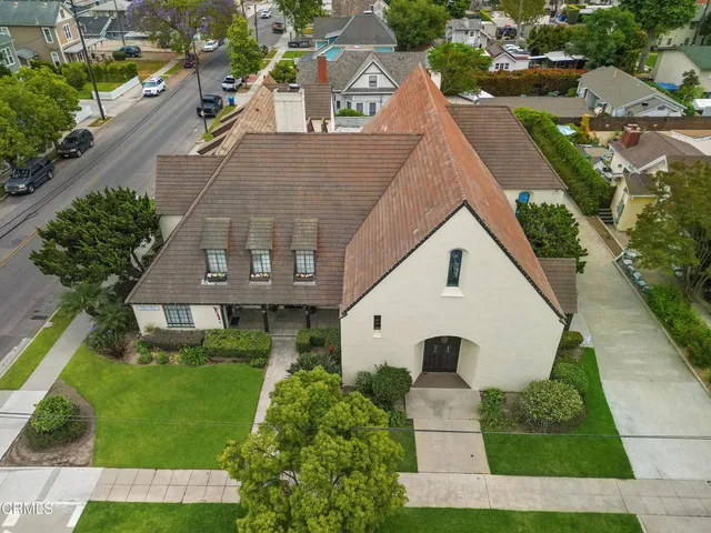 an aerial view of a house with a yard and potted plants