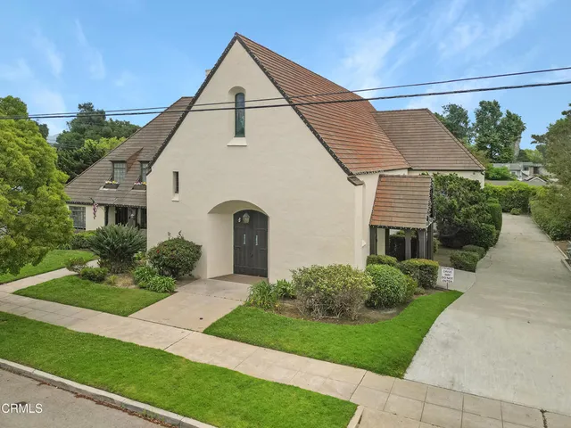 a view of house with garden and tall windows
