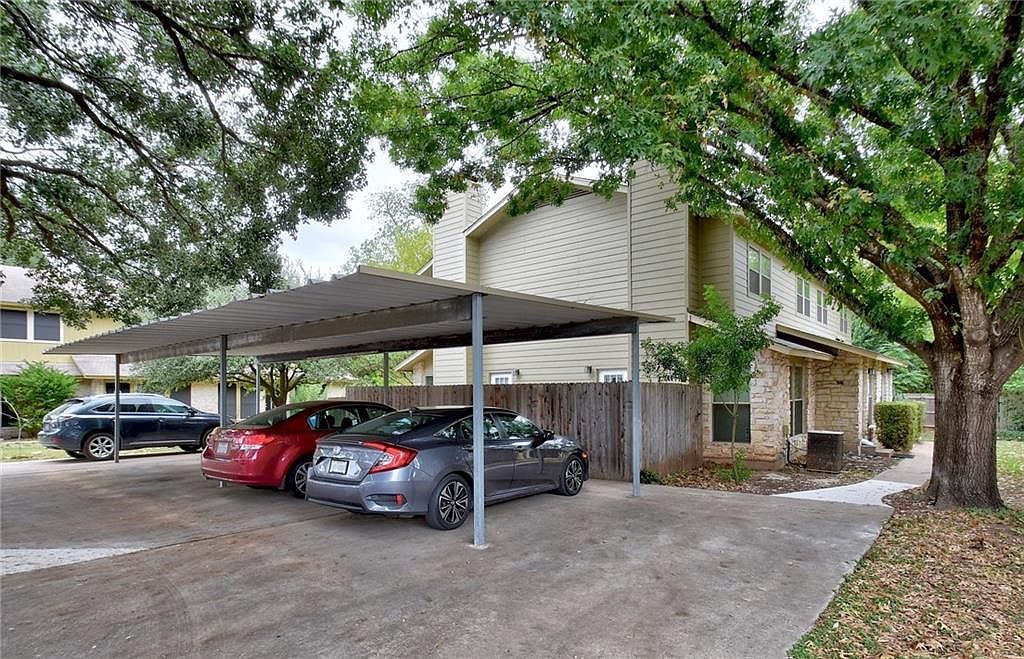 1401 Camp Craft Road, Unit C Austin, TX 78746 - Photo 7 of 12 A private driveway and carport offer protected parking alongside the inviting exterior of this property.
