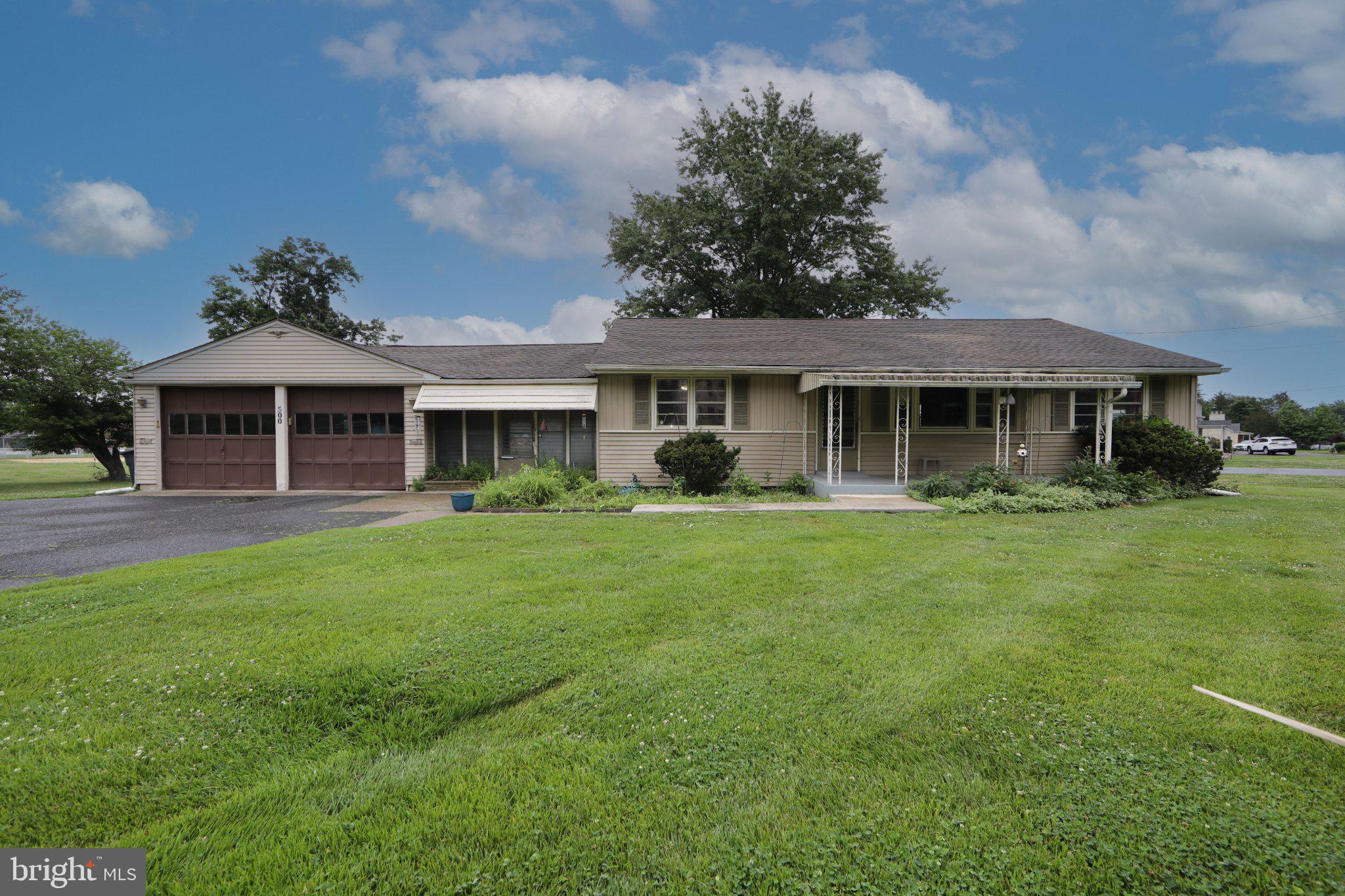 Charming home with lush green lawn.
