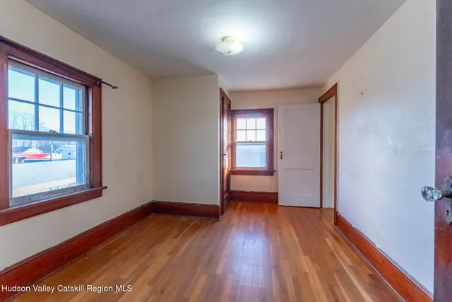 wooden floor in an empty room with a window