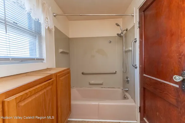 a bathroom with a shower and a bath tub