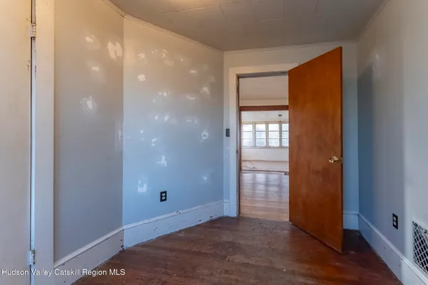 wooden floor in an empty room with a window