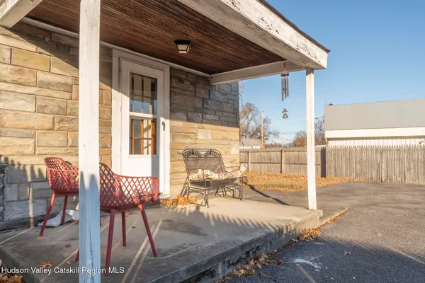 a view of a patio with table and chairs