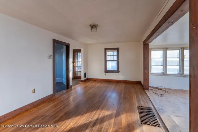 wooden floor in an empty room with a window