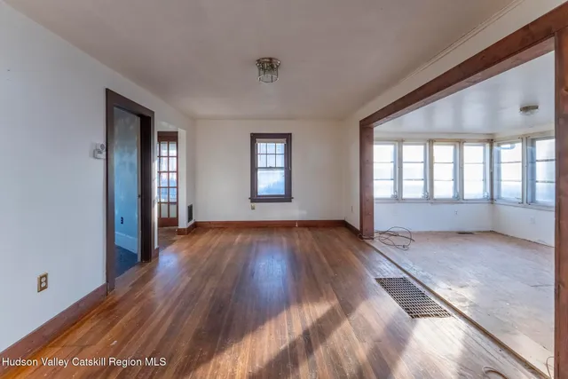 wooden floor in an empty room with a window
