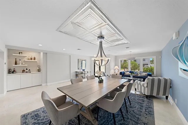 a living room with furniture a ceiling fan and a window
