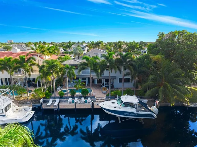 a kitchen with stainless steel appliances kitchen island granite countertop a sink a microwave a stove and a refrigerator