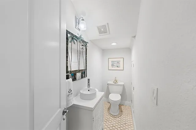 a view of a chairs and table in patio with wooden fence
