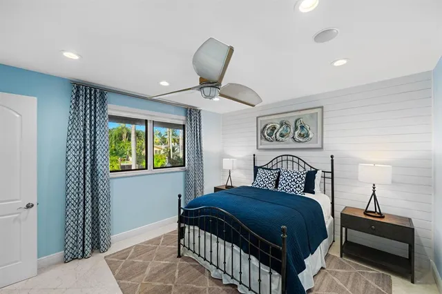 a bedroom with a large bed and a window