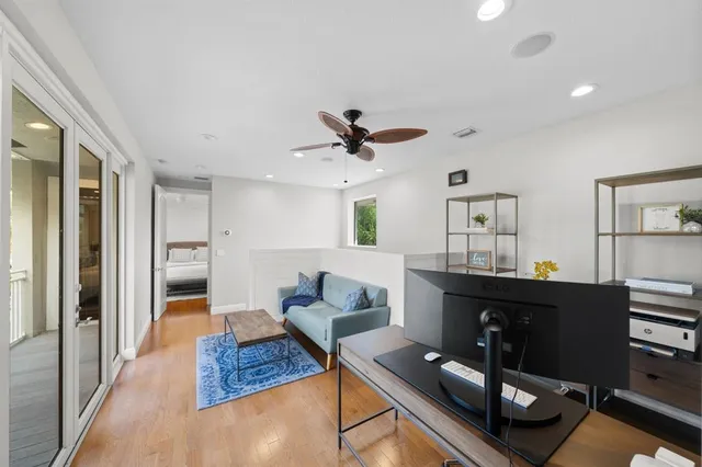 a view of a patio with couches table and chairs potted plants and palm tree