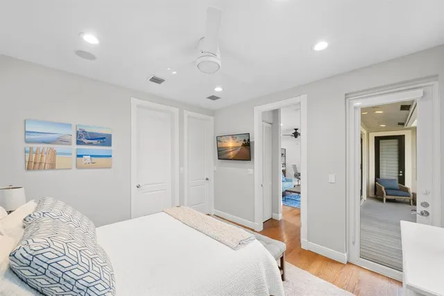 an aerial view of residential houses with outdoor space and trees