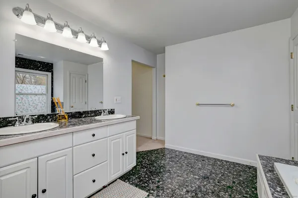 a bathroom with a sink a vanity and a mirror
