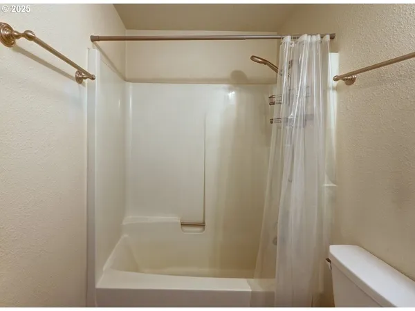 a bathroom with a shower and a toilet