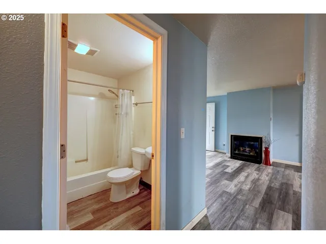 a bathroom with a toilet and a shower