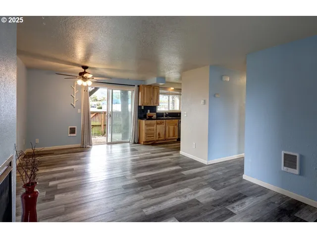 a view of a kitchen with a dishwasher and wooden floor