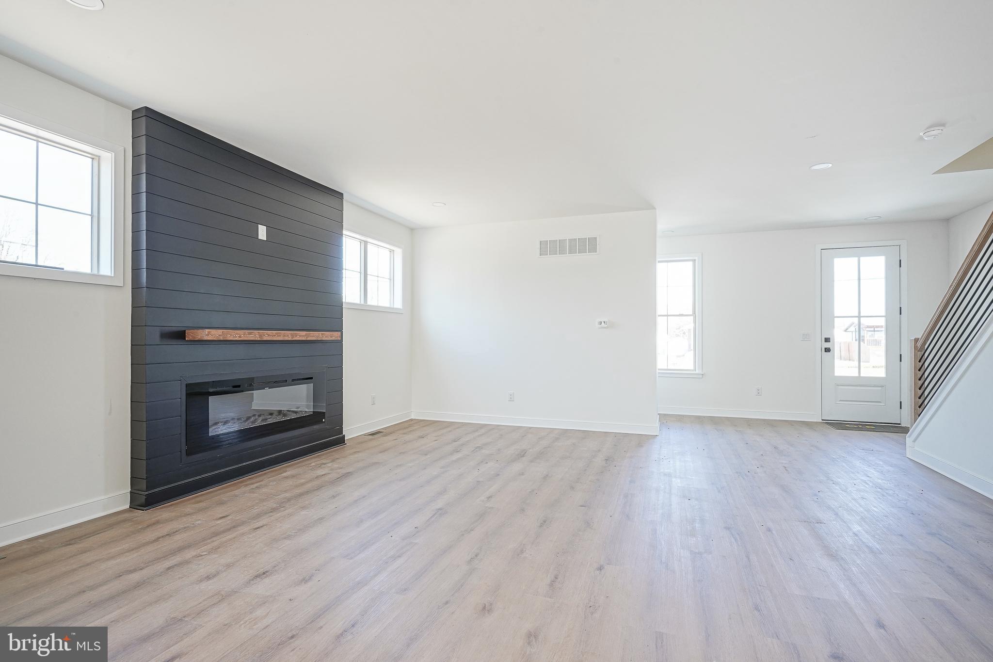 35 West Cohawkin Road Clarksboro, NJ 08020 - Photo 8 of 30 a view of an empty room with wooden floor fireplace and a window