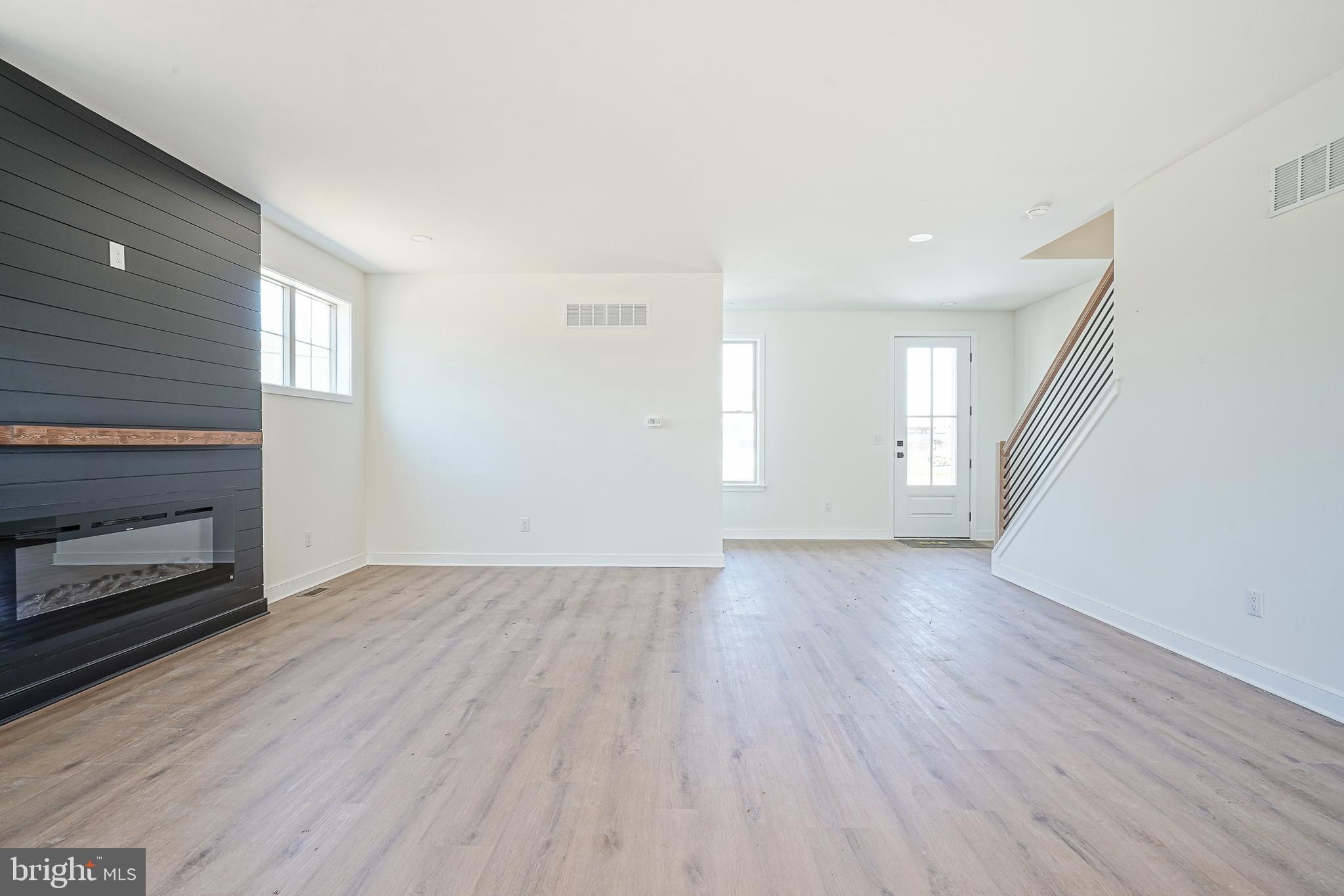 35 West Cohawkin Road Clarksboro, NJ 08020 - Photo 9 of 30 an empty room with wooden floor fireplace and windows