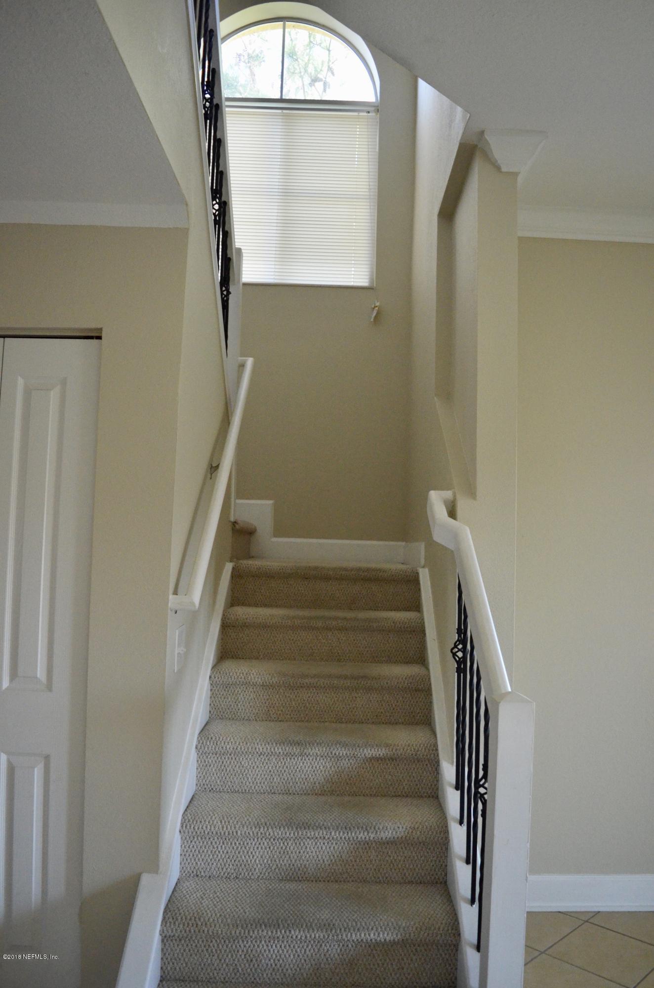 9745 Touchton Road, Unit 1821 Jacksonville, FL 32246 - Photo 15 of 33 a view of staircase with white walls and a window