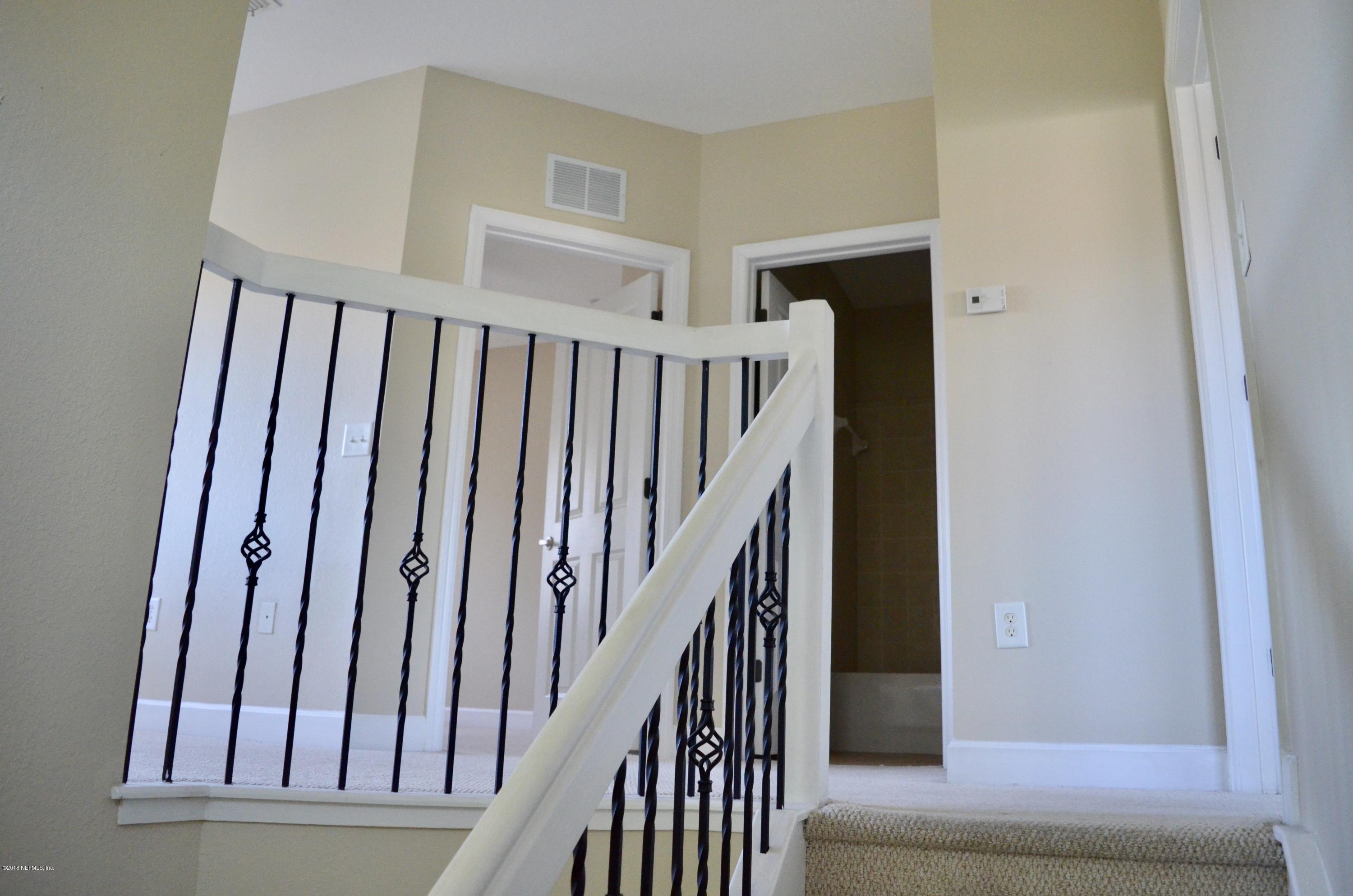 9745 Touchton Road, Unit 1821 Jacksonville, FL 32246 - Photo 16 of 33 a view of staircase with wooden floor and staircase