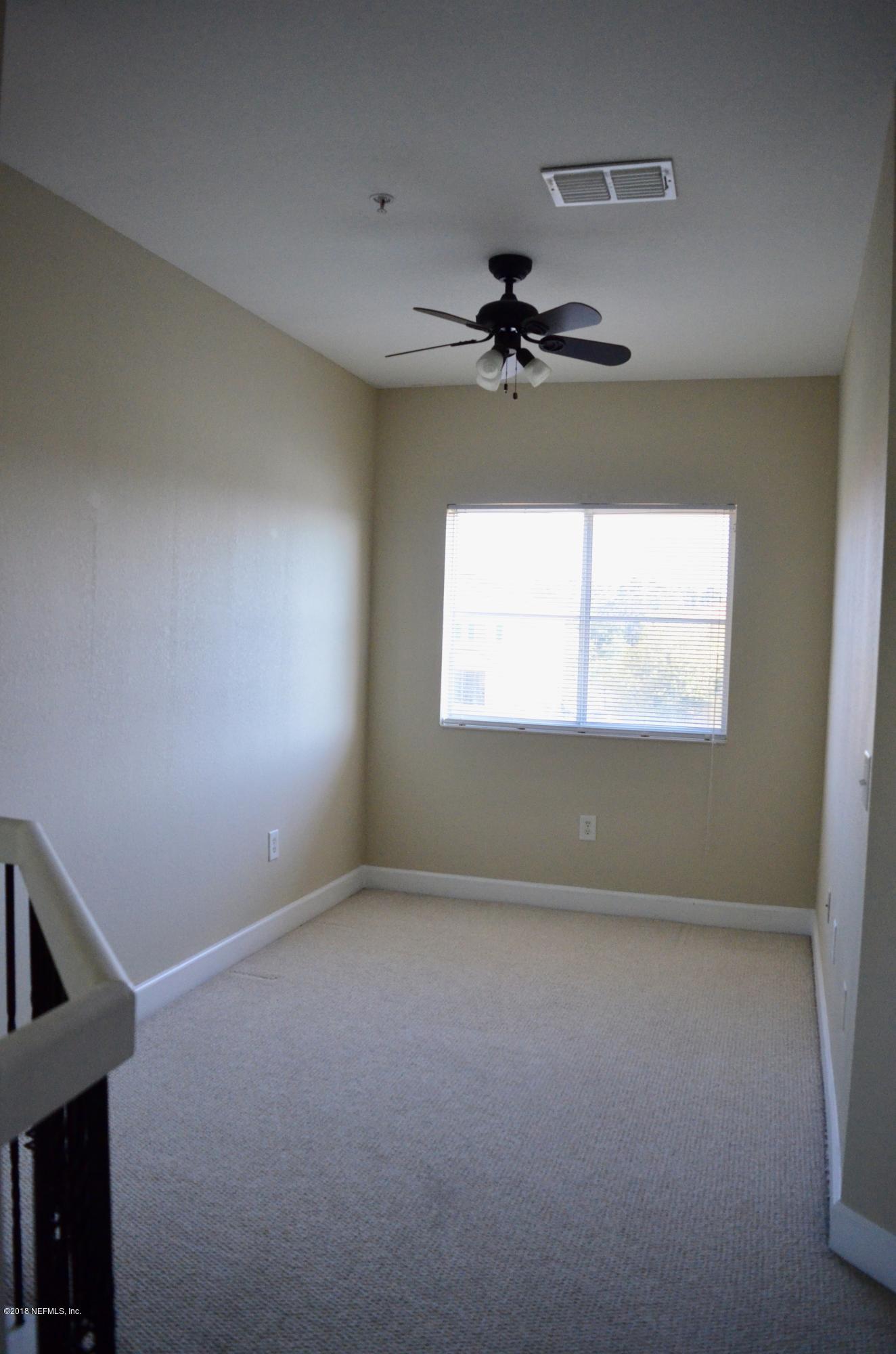 9745 Touchton Road, Unit 1821 Jacksonville, FL 32246 - Photo 17 of 33 a view of an empty room with a window