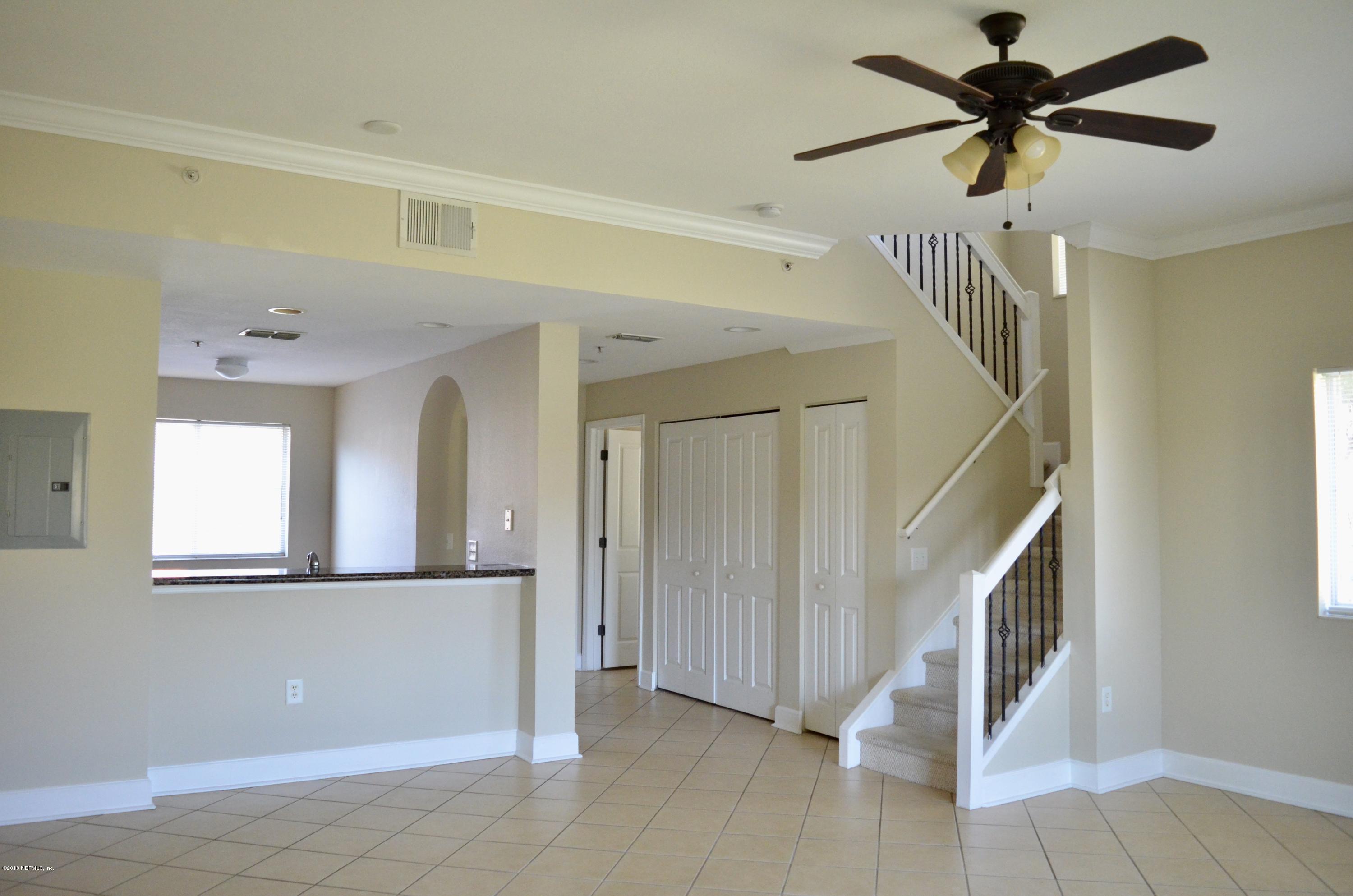 9745 Touchton Road, Unit 1821 Jacksonville, FL 32246 - Photo 2 of 33 a view of a livingroom with a ceiling fan and window