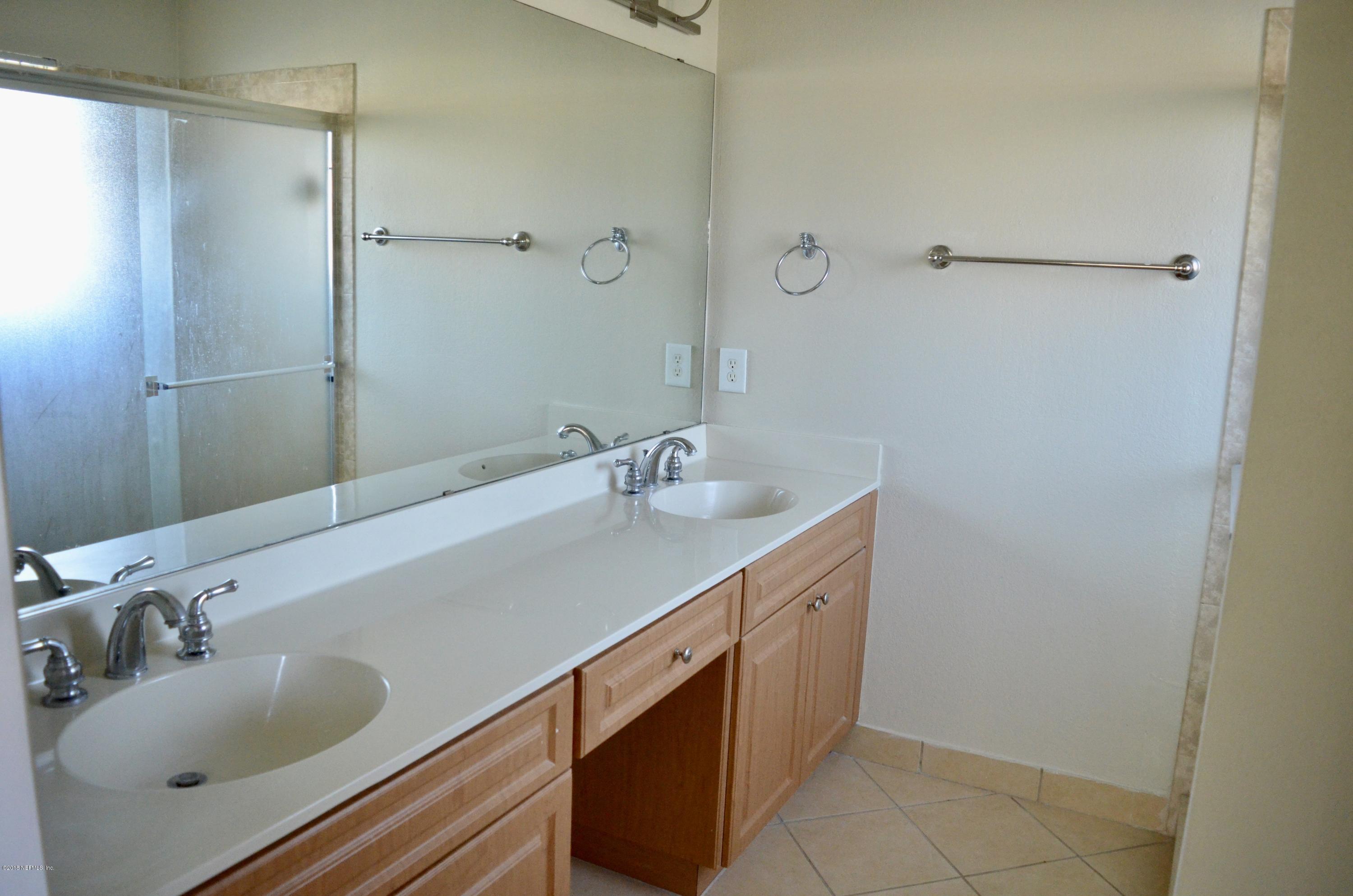 9745 Touchton Road, Unit 1821 Jacksonville, FL 32246 - Photo 26 of 33 a bathroom with a sink and a mirror
