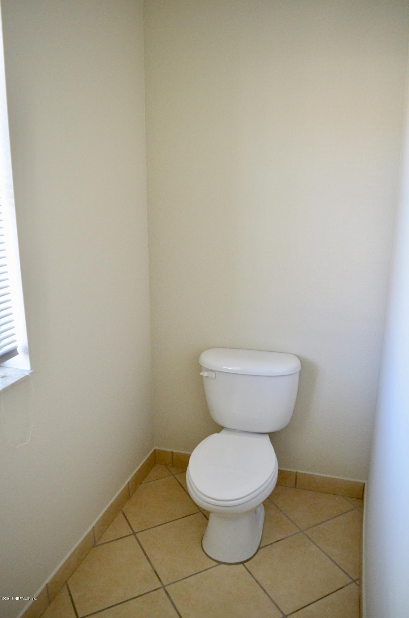 9745 Touchton Road, Unit 1821 Jacksonville, FL 32246 - Photo 5 of 33 a bathroom with a toilet