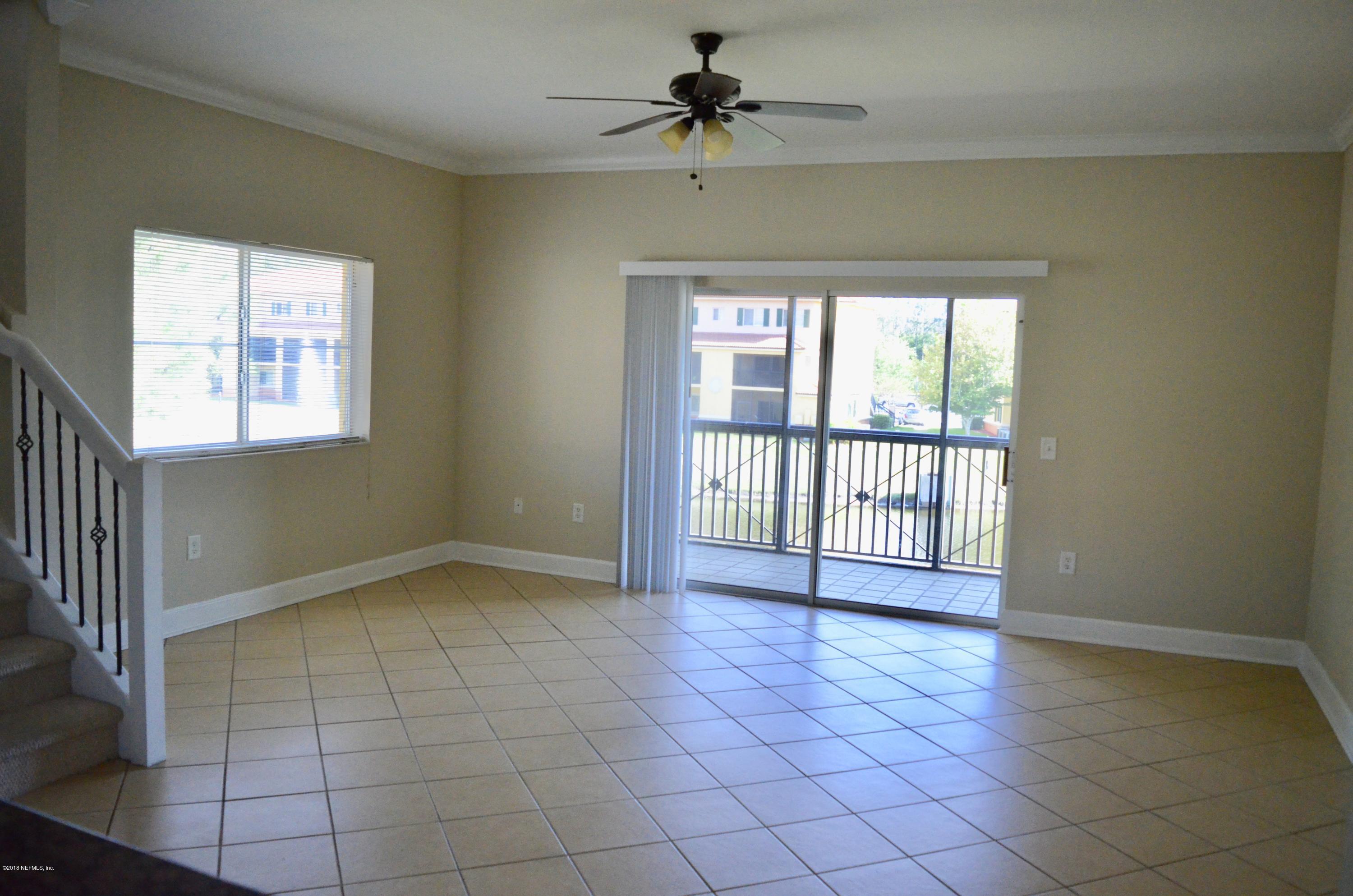 9745 Touchton Road, Unit 1821 Jacksonville, FL 32246 - Photo 9 of 33 an empty room with windows and fan