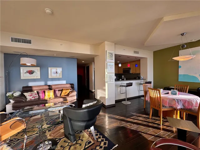 a dining room with furniture and wooden floor