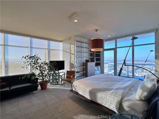 a bedroom with a large bed and a chandelier