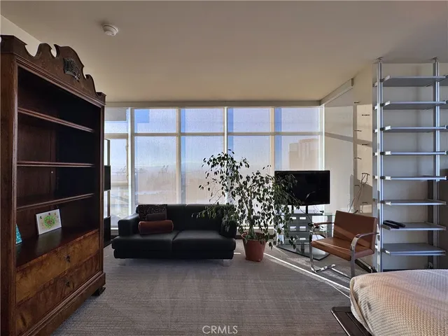 a view of a bedroom with a bed and a large window