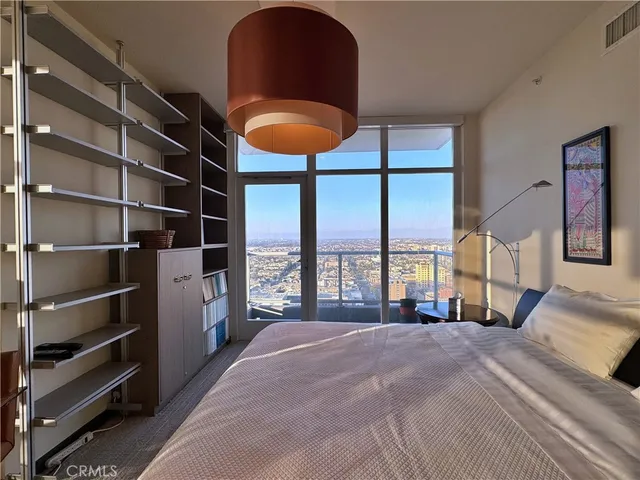 a bathroom with a granite countertop sink a toilet a mirror and shower