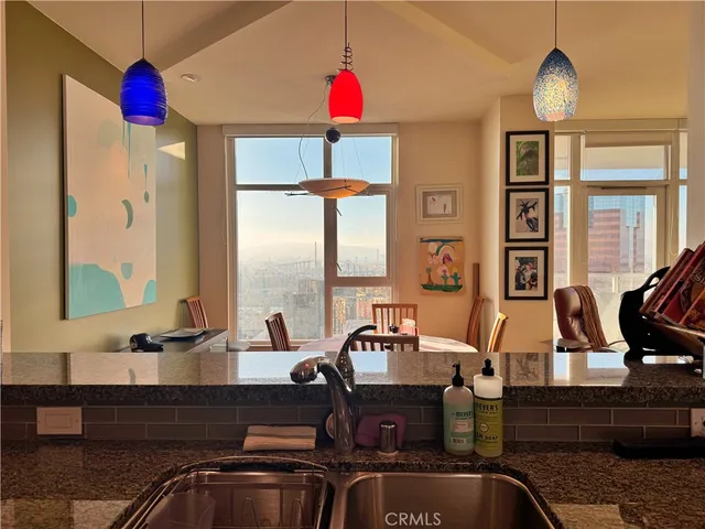 a kitchen with granite countertop a sink and cabinets
