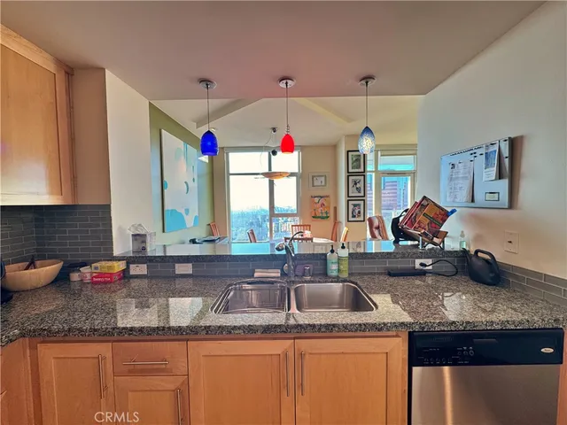 a kitchen with stainless steel appliances granite countertop a stove microwave and sink