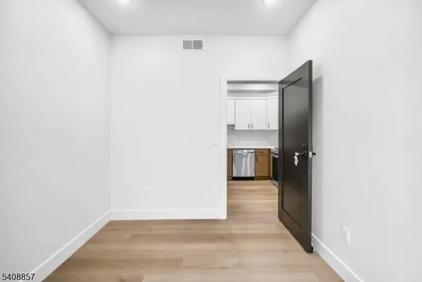 a view of a kitchen with a sink and a refrigerator