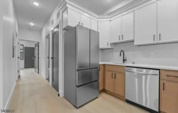 a kitchen with a refrigerator and a stove top oven