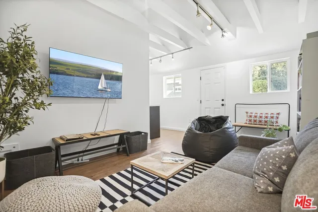 a bathroom with a sink a toilet a mirror and shower