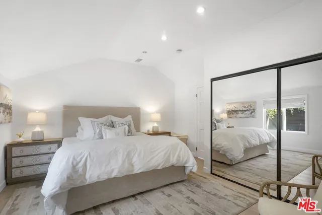 a patio with a table and chairs and potted plants