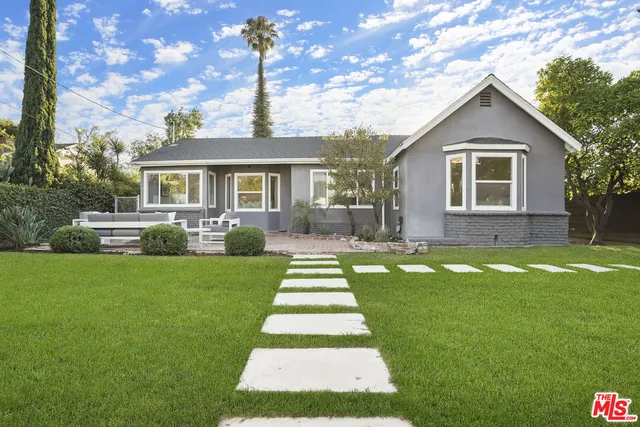 a view of a patio with couches table and chairs and potted plants